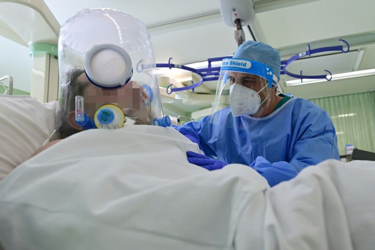 A member of the medical staff wearing personal protective equipment (PPE) tends to a patient in the Covid-19 unit of the Bolognini hospital in Seriate, Bergamo