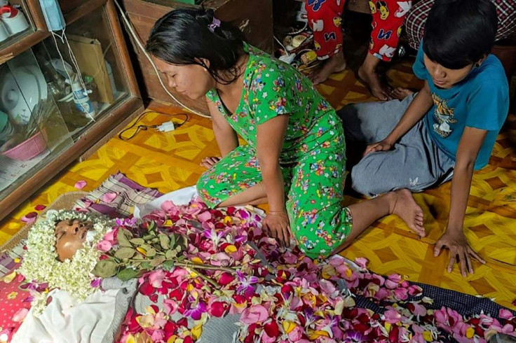 Relatives pay their respects to Aung Than, also known as Aung Aung Zaw, a supporter of the National League for Democracy party, after he was killed overnight in Thaketa township in Yangon