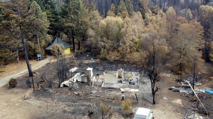 People rebuild a house in the town of Las Golondrinas on March 11, 2021 after a forest fire in Argentina's Chubut province