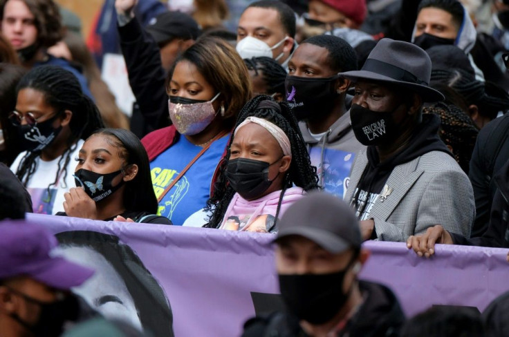 Tamika Palmer, Breonna Taylor's mother, holds a banner as she marches during a rally on the one-year anniversary of Taylor's death in Louisville, Kentucky on March 13, 2021