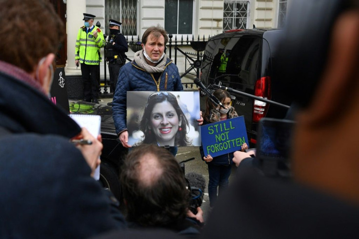 Richard Ratcliffe, husband of British-Iranian Nazanin Zaghari-Ratcliffe jailed in Tehran since 2016, and his daughter Gabriella, attend a protest outside of the Iranian Embassy in London on March 8