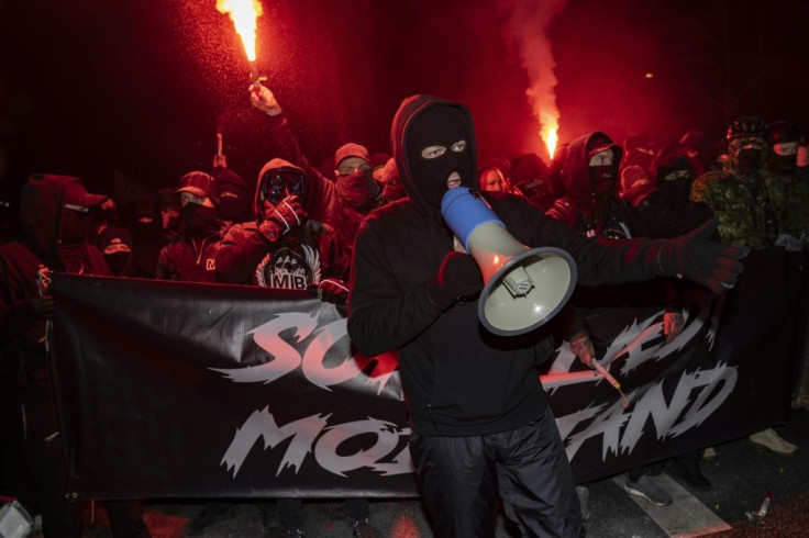 Supporters of the "Men in Black Denmark" movement demonstrate against restrictions implemented to fight the spread of the novel coronavirus on two people were arrested on the sidelines of a weekend protest against anti-coronavirus restrictions in Copenhag