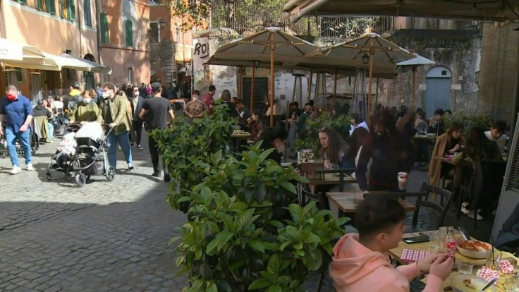 IMAGESItalians eat at restaurants and walk the streets of Trastevere in Rome on the eve of a partial lockdown. Schools, restaurants, shops and museums will close across most of the country, a year after it became the first European country to face a major