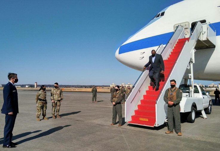 US Defense Secretary Lloyd Austin (2nd R) gets off a plane upon his arrival at the US Yokota Air Base in Tokyo