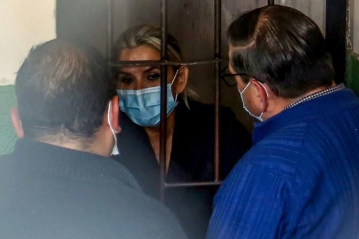 Former caretaker president Jeanine Anez speaks with her lawyers from a prison cell in La Paz on March 13, 2021