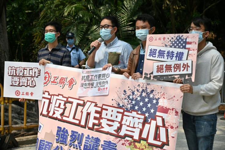 Members of the Hong Kong Federation of Trade Unions protest outside the United States consulate in Hong Kong after two staff tested positive for Covid-19