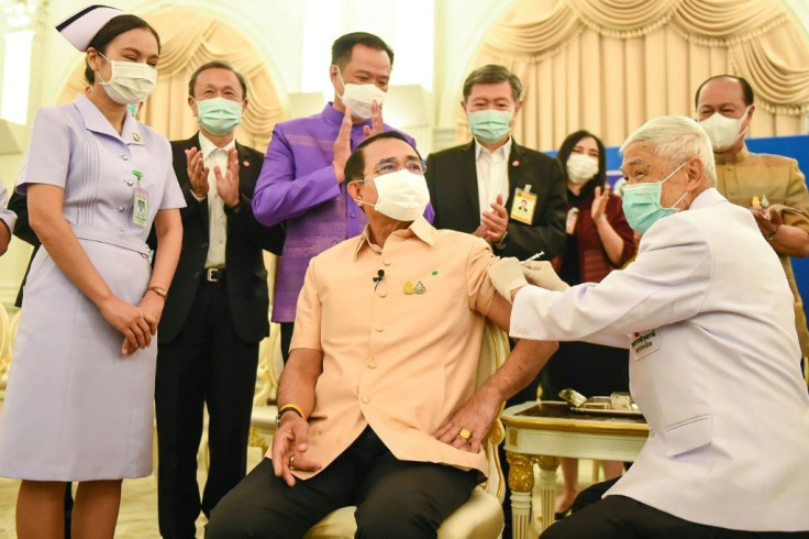 Thailand's Prime Minister Prayut Chan-O-Cha (C) said he took the AstraZeneca vaccine as an "example"