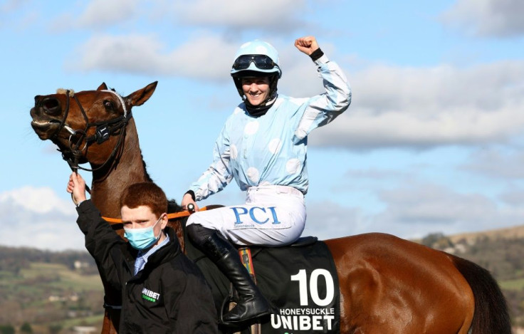 Jockey Rachael Blackmore celebrates her victory on Honeysuckle in the Champion Hurdle at Cheltenham