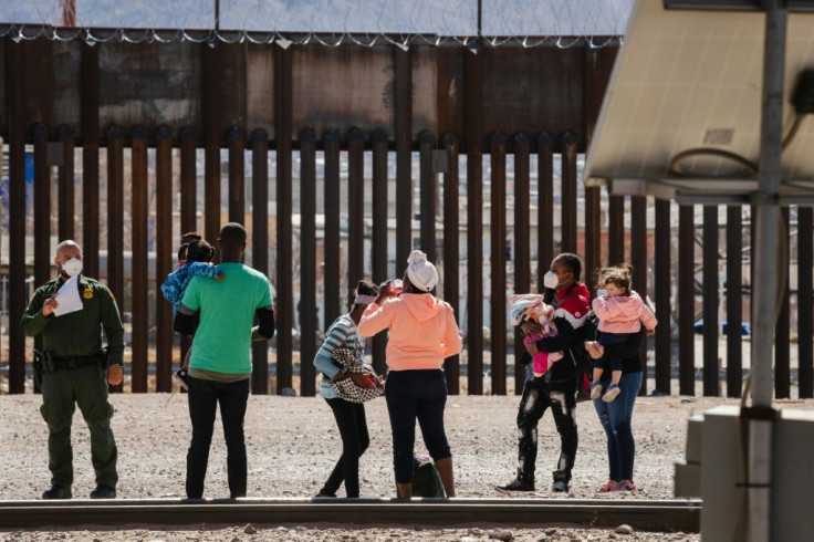 Border Patrol agents apprehend a group of migrants near downtown El Paso, Texas on Monday