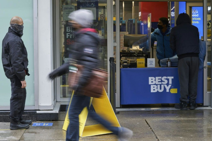 Customers wait outside a Best Buy store in downtown Toronto, Canada on November 23, 2020 to pick up online orders