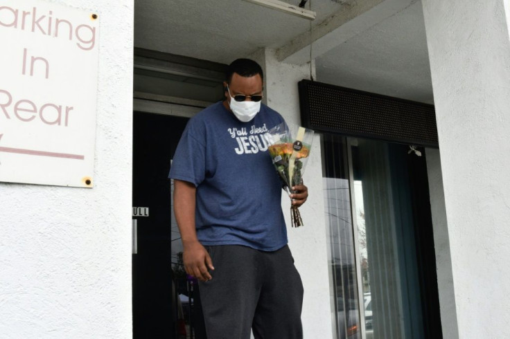 Yalaba Mendoza lays flowers at the Gold Spa in Atlanta on March 17, 2021