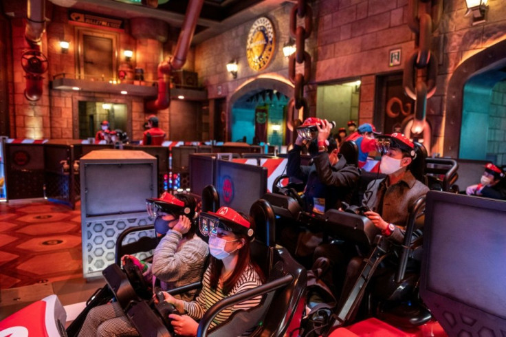 Augmented reality goggles attached to a plastic red visor are used in the 'Mario Kart' ride