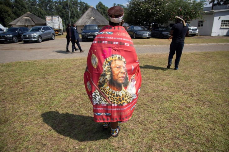 An elderly Zulu woman wore clothing with the face of the late king