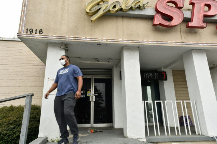A man places flowers at the Gold Spa in Atlanta, Georgia, one of the businesses targeted in Tuesday's violence