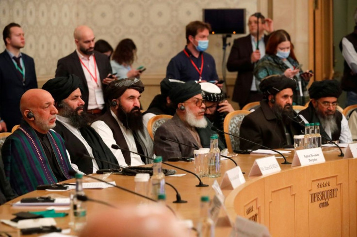 Former Afghan president Hamid Karzai (L) and Taliban co-founder Mullah Abdul Ghani Baradar (2R) at the conference