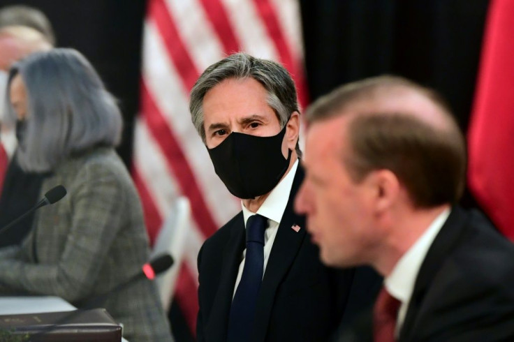 US National Security Advisor Jake Sullivan (R) speaks as US Secretary of State Antony Blinken (C) looks on at the opening session of US-China talks