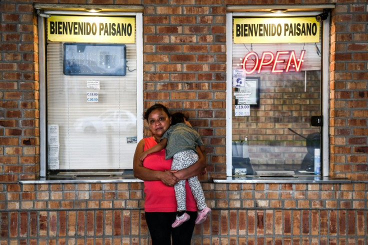 Jilsa Revolorio, a migrant form Guatemala, poses with her daughter Camilla Revolorio as they wait for a bus at a station near the Gateway International Bridge, between the cities of Brownsville, Texas, and Matamoros, Mexico March 16, 2021