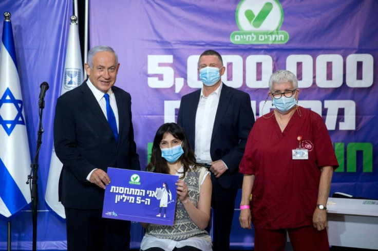 Veteran incumbent Benjamin Netanyahu has sought to take credit for Israel's coronavirus vaccination effort which is the envy of many nations -- here he is seen posing earlier this month with the five millionth citizen to receive a first shot