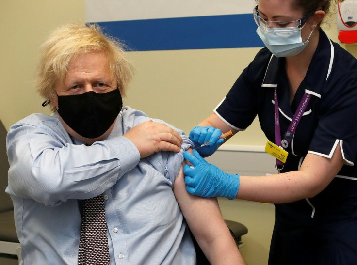 Britain's Prime Minister Boris Johnson receives a dose of the AstraZeneca/Oxford vaccine, administered by nurse Lily Harrington in St Thomas' Hospital. London