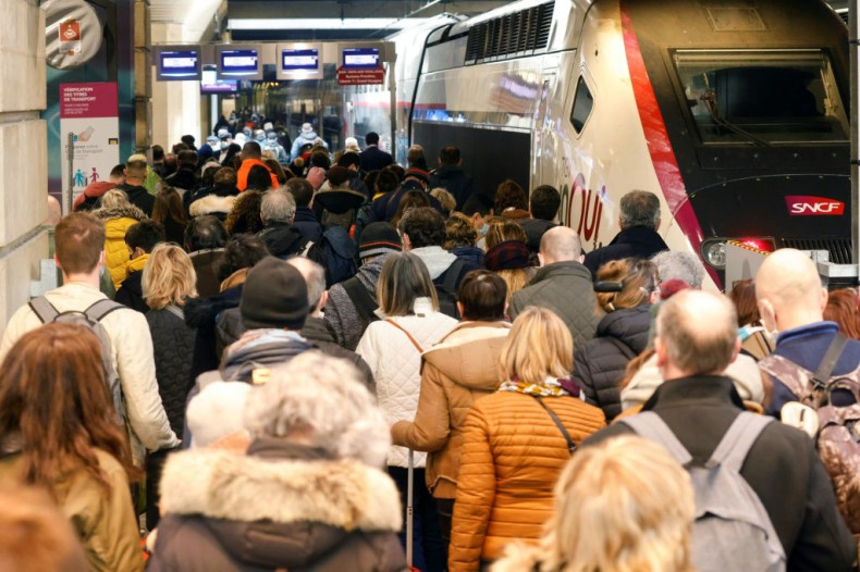 Parisians pack into crowded trains to get out of the French capital before a new month-long partial lockdown begins