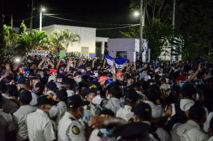 Thousands of Honduran migrants pushing through a police barrier as they attempt to cross the border at El Florido in Guatemala on their way to the United States on January 15, 2021.