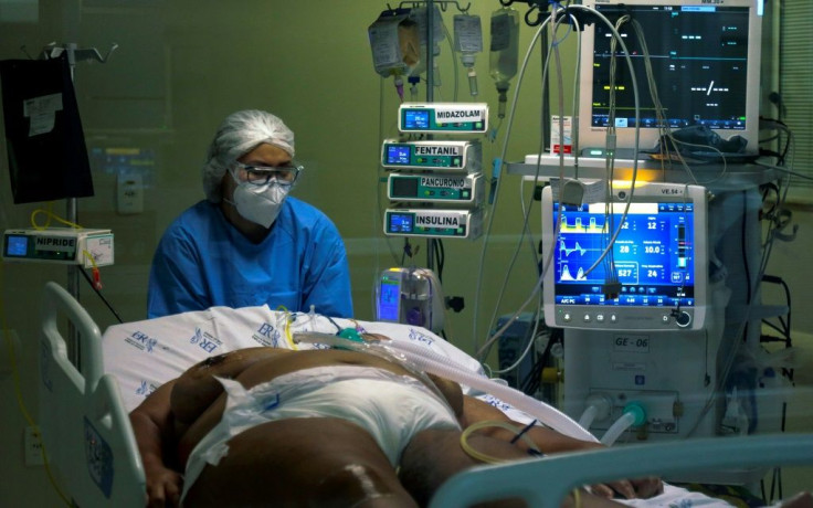 A health worker cares for a Covid-19 patient in the intensive care unit of Emilio Ribas Hospital in Sao Paulo, Brazil, on March 17, 2021