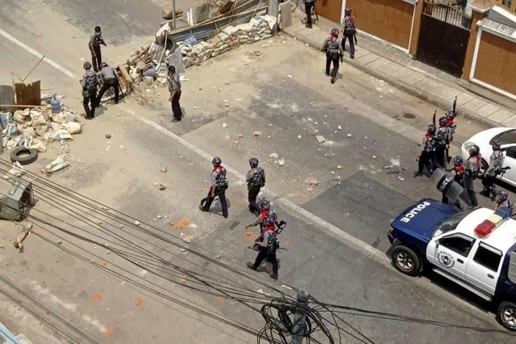 Security forces remove a barricade across a road in Yankin township in Yangon as a crackdown on demonstrations against the military coup continues