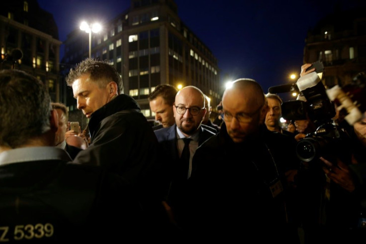 Charles Michel, who was Belgium's prime minister, recalls the 'terrible shock' of the bomb attacks in Brussels five years ago. Michel, in the centre, is pictured heading to a makeshift memorial the day of the events