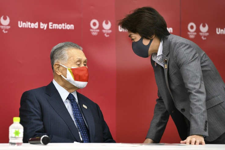 In this file photo taken on December 4, 2020, Yoshiro Mori (L) chats with Olympic Minister Seiko Hashimoto (R)