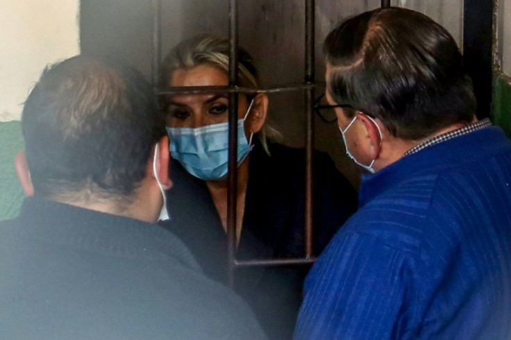 Bolivia's former interim president Jeanine Anez speaks with her lawyers from a jail cell on March 13, 2021