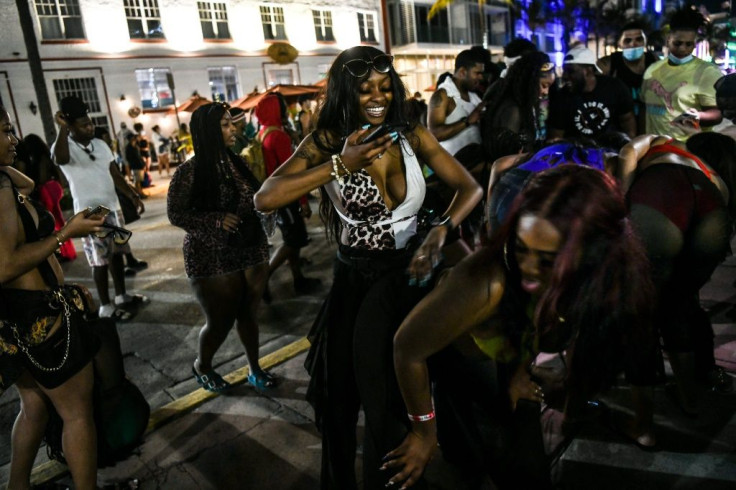 People dance on Ocean Drive in Miami Beach, on March 17, 2021