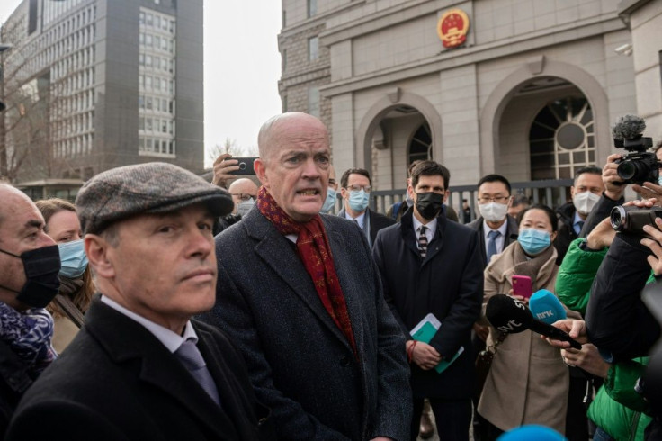 Jim Nickel, from Canada's Beijing embassy (L), told reporters that the trial had started and that diplomats had been denied permission to attend