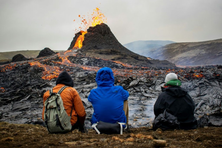 Sunday hikers watch the lava flowing from the erupting Fagradalsfjall volcano