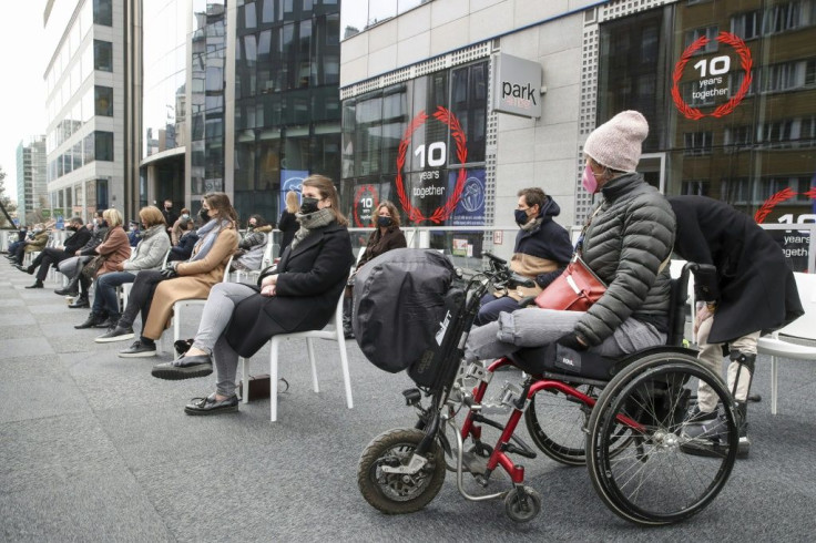 Survivors, relatives and officials attend a ceremony for victims of the March 22, 2016 attacks that came against a backdrop of criticism of the slowness of the administration and insurance companies to deal with the human suffering