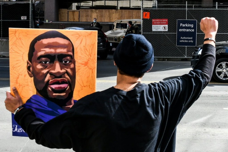 A demonstrator holds a portrait of George Floyd outside the Hennepin County Government Center in Minneapolis, Minnesota