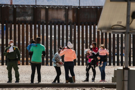 US Border Patrol agents with a group of migrants near downtown El Paso, Texas, on the border with Mexico on March 15, 2021