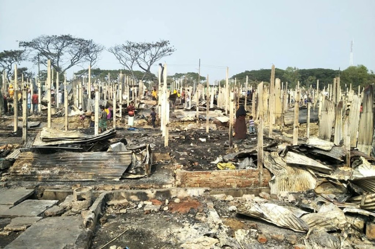 Rohingya refugees sift through the ashes after a fire broke out at Nayapara refugee camp in Teknaf, south of Cox's Bazar, on January 14, 2021