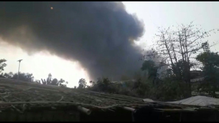 A video captured by a member of a local NGO shows Rohingya refugees fleeing from a camp in southeastern Bangladesh as thick columns of smoke rise above shanty homes. Duration:00:33