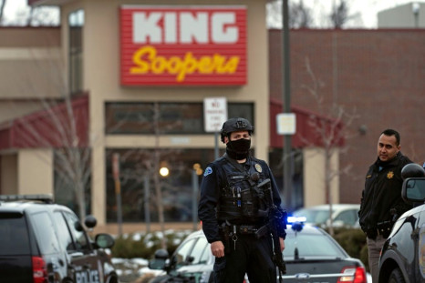 Police officers secure the perimeter of the King Soopers grocery store in Boulder, Colorado -- scene of a deadly shooting