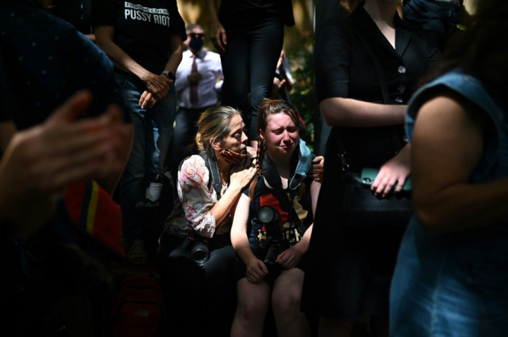 A protester is comforted during a rally against sexual violence and gender inequality in Sydney