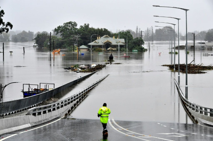 A rescue worker stands at the entrance to Windsor Bridge after the area was inundated with floods in the Windsor area in northwestern Sydney on March 23, 2021, after torrential downpours have lashed Australia's southeast for days.