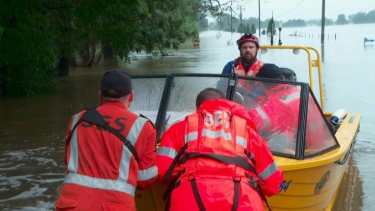 Rivers remain high in a suburb in the Australian city of Sydney as rain falls, pushing up floodwaters that have inundated homes and roads.