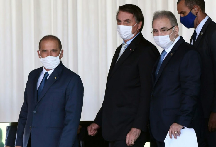 Brazilian President Jair Bolsonaro (C), new Health Minister Marcelo Queiroga (R) and General Secretariat of the Presidency Onix Loranzoni meet with the press after discussing possible solutions for the Covid-19 pandemic March 24, 2021