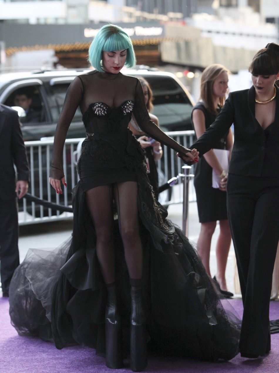 Gagas latest look at the CFDA awards spikey black dress, an aquamarine bob and sky high plaform boots