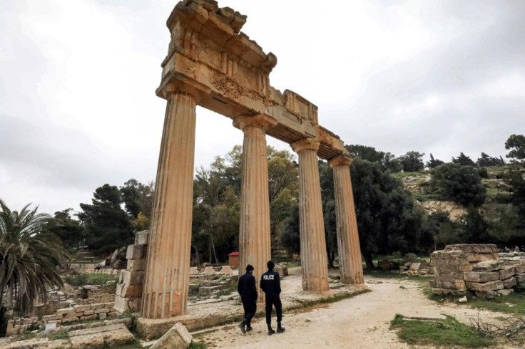 Local policemen patrol by a colonnade from the remnants of the Temple of Demeter in Cyrene