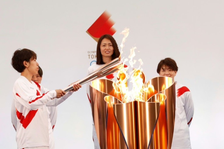 Iwashimizu (L), lit the torch at the departure ceremony in Fukushima