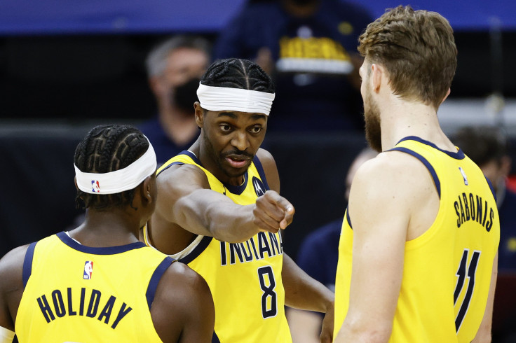 Justin Holiday #8 of the Indiana Pacers gives directions to Aaron Holiday #3 and Domantas Sabonis #11