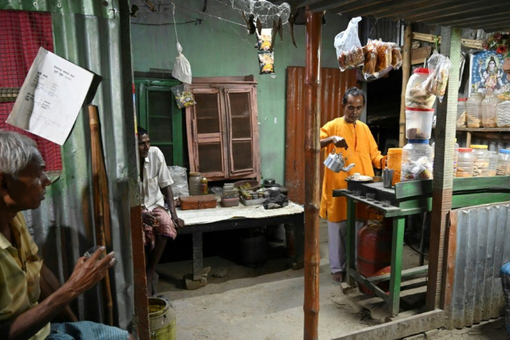 Sunil Pramanik (R), father of murdered BJP worker Sukhdev Pramanik, works in a tea stall his son used to run in Chandpara