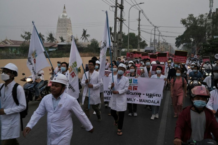 Myanmar medical personnel take part in a dawn protest against the military coup in Mandalay