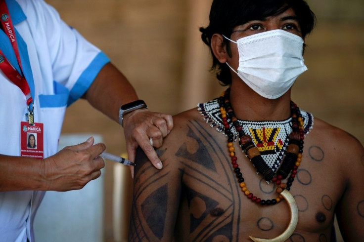 A Guarani indigenous man recieves a Covid vaccine in Brazil